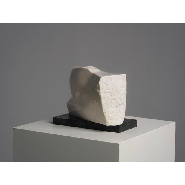 A refined abstract marble sculpture titled noise, created in the netherlands during the 1990s. Carved from a solid block...