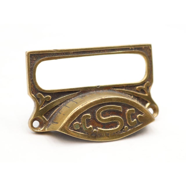 Antique Victorian style brass bin drawer pull engraved C.S.C on the front. The original mounting screws are not available....