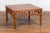 A Chinese late Qing Dynasty period natural elm coffee table from the early 20th century, with open apron, pillar strut...