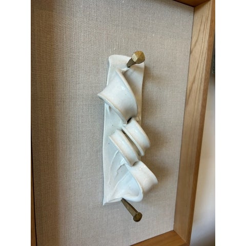 Vintage sculptural relief mounted within a newly constructed custom frame. The original piece features an abstract, folded...