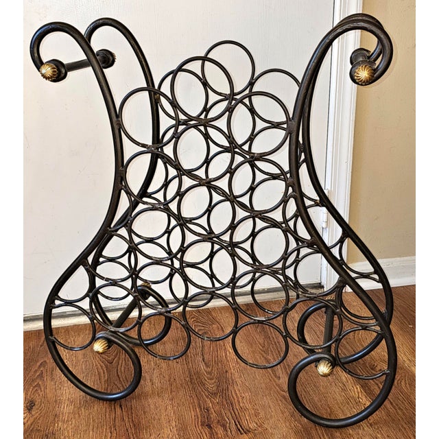A late 20th Century French Wrought Iron and Brass Wine Rack. Dark brown painted with plastic inserts to protect bottle...