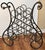 A late 20th Century French Wrought Iron and Brass Wine Rack. Dark brown painted with plastic inserts to protect bottle...