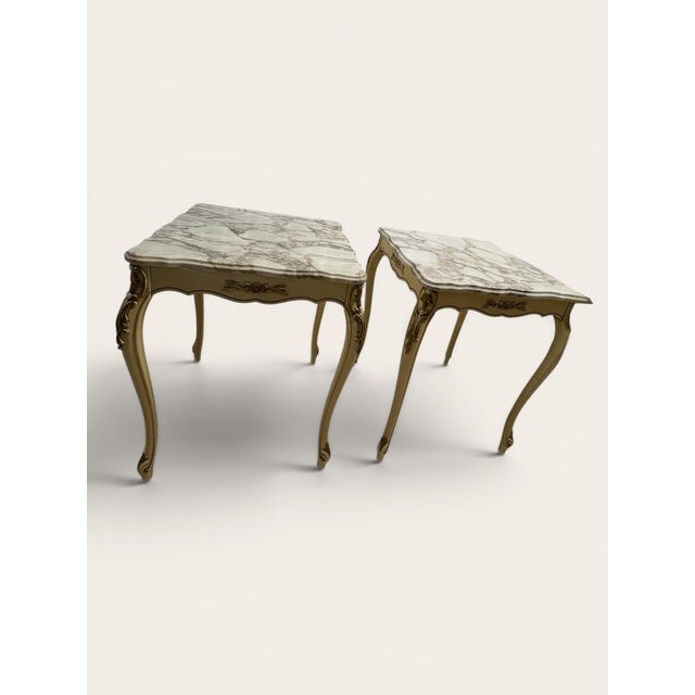 These Mid 20th-century French Louis XV style tables feature hand-carved giltwood frames with ornate acanthus leaf motifs....