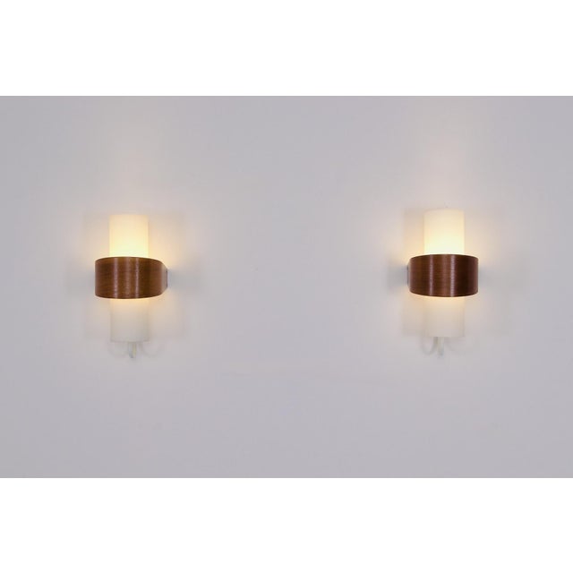 Nx40 wall lights by louis kalff for philips, produced from 1959 onwards. Each piece features a white lacquered aluminum...