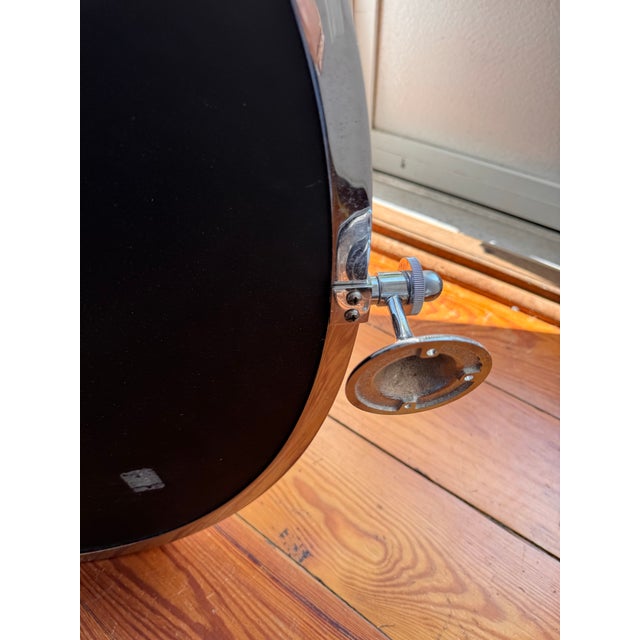 Pottery Barn polished chrome-finished round mirror with a metal frame. This wall-mounted piece has adjustable pivot...