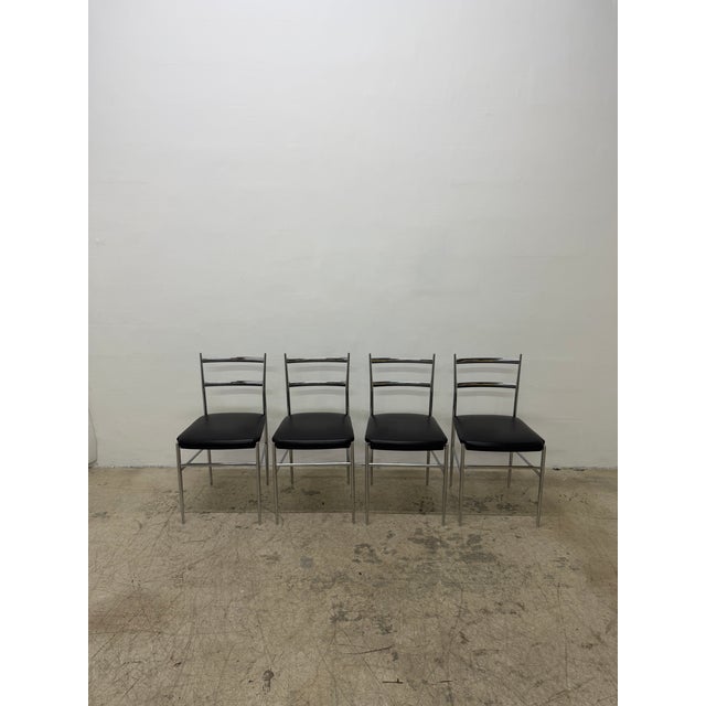 Set of four original Otto Gerdau chrome dining chairs with black Naugahyde seats circa 1960s, Italy.