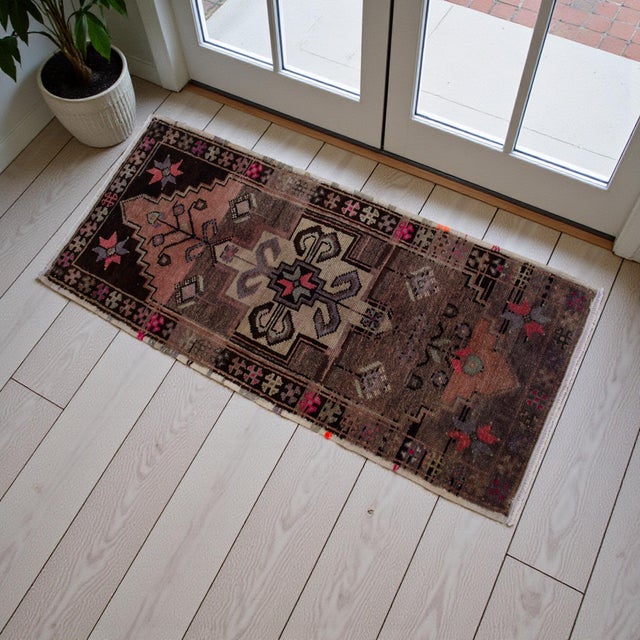 This vintage Anatolian gem features a moody, earth-toned palette with a striking geometric medallion and whimsical floral...