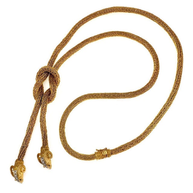 This magnificent necklace is crafted from 18k yellow gold and has white gold accent featuring a 6mm thick weave link...