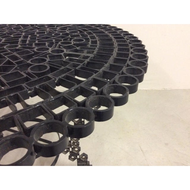 Brutalist table wrought iron painted black.