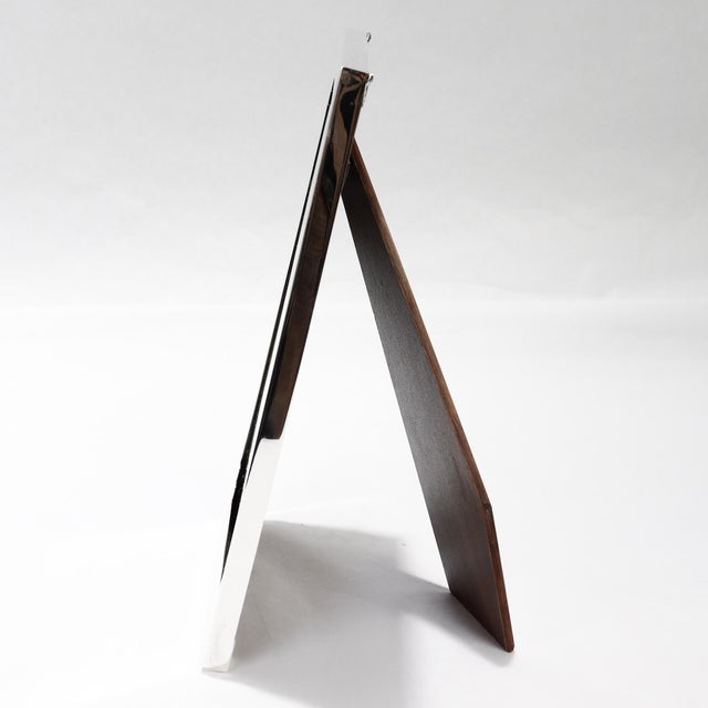 A fine signed silver picture frame. By Cartier. In sterling silver with engraved line decoration. With a robust easel back...