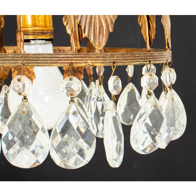 Hollywood Regency gilt metal ceiling pendant 1960s with leaf-form canopy and two concentric rings of cut-glass crystals...