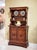 Antique Italian Tuscan buffet and hutch handcrafted from solid walnut. The upper hutch features open display shelves with...
