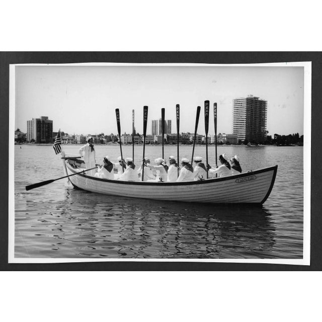 1986 black & white photograph of the Sunday Woman plus rowing club. Publication information on the back.