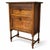 A beautifully proportioned antique oak cabinet featuring a compact two-tier design, raised on elegant turned legs with...