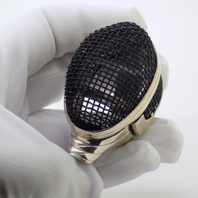 Striking and exceptionally rare, this vintage italian continental silver figurine depicts a finely detailed fencing mask....