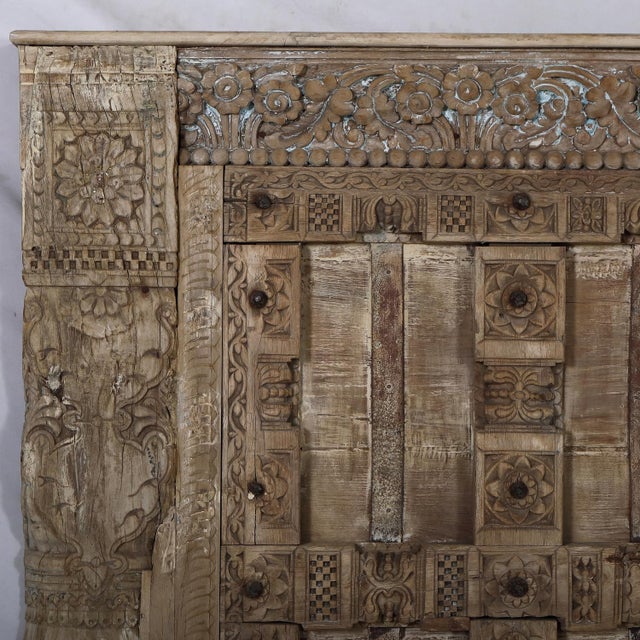Headboard constructed from antique Indian teakwood doors and carved pillars, celebrating the rich craftsmanship of...