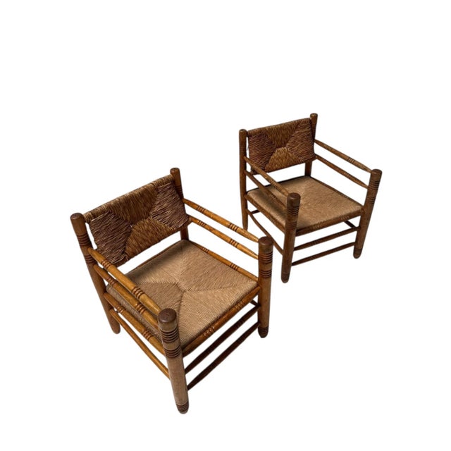 Stunning and elegant pair of Mid-Century Modern armchairs. Design in the style of Audoux-Minet. Striking French design...