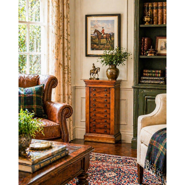 A distinguished example of 19th-century English furniture design, this antique Wellington cabinet showcases both refined...