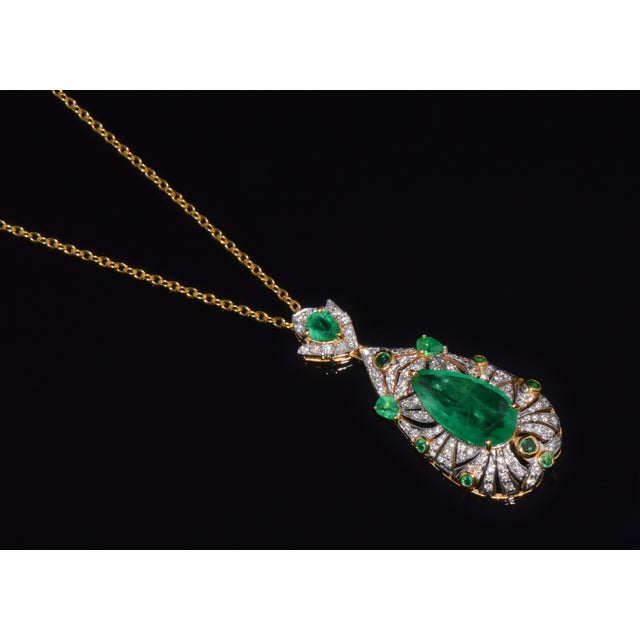 Natural emerald and diamond pendant crafted in solid 18K gold, featuring an approximately 3-carat pear-shaped center...