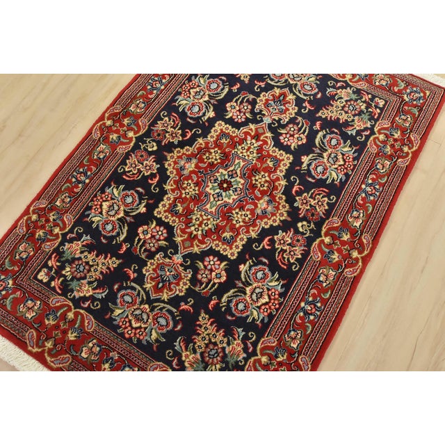An authentic vintage traditional Qom rug hand-knotted with fine wool and natural dyes. This intricately woven rug features...