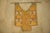A strange, suspended composition combining embroidered textiles, triangular mirror inlays, and polychrome metallic...