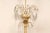 An Italian crystal and gilt-wood column chandelier from the mid 20th century. This mid-century hanging light from Italy...
