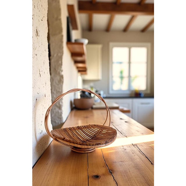 Large Mid-Century rattan basket with a sturdy arched handle. Well-crafted and versatile in use. Suitable as a fruit bowl,...