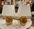 Elevate your space with this elegant pair of table lamps featuring a warm, reflective brass base and classic tapered cream...