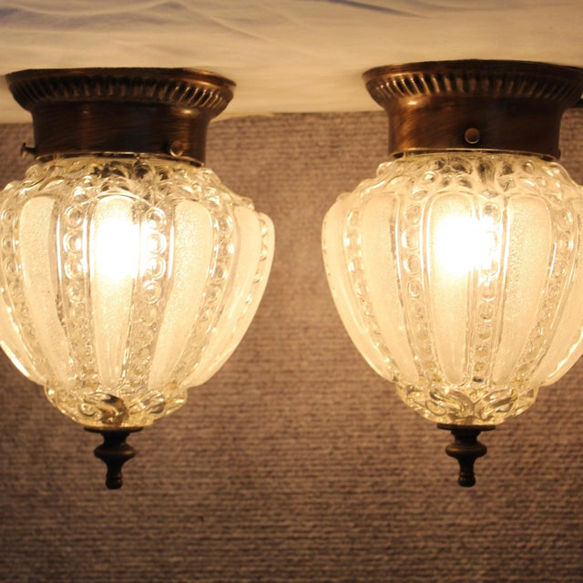 Glass shade with alternating vertical panels of smooth, frosted satin glass and clear, textured ribs lined with a bubble...