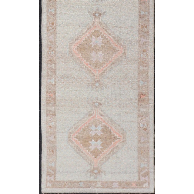 Measures: 3'4 x 11'6 Turkish Oushak Runner with Soft Ivory Field and Peach Geometric Medallions. Keivan Woven Arts. rug...