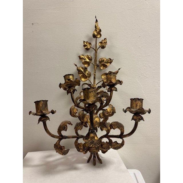 Antique Italian wall sconce candelabra featuring an elegant gilt gold leaf motif and five candle arms. Crafted with finely...