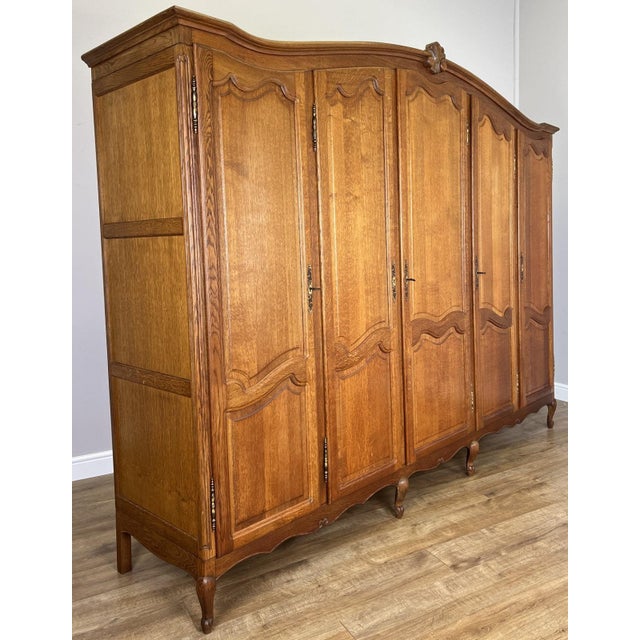 An impressive Vintage French Louis wardrobe crafted in oak , offering generous storage within an elegant five-door design....