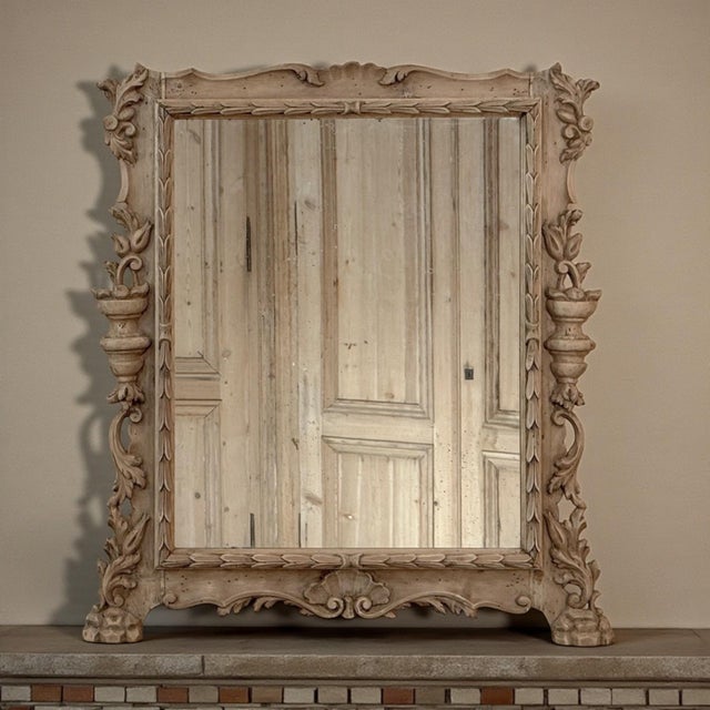 Elegant Italian hand-carved walnut mirror, beautifully bleached to reveal the quiet warmth of the wood and the depth of...