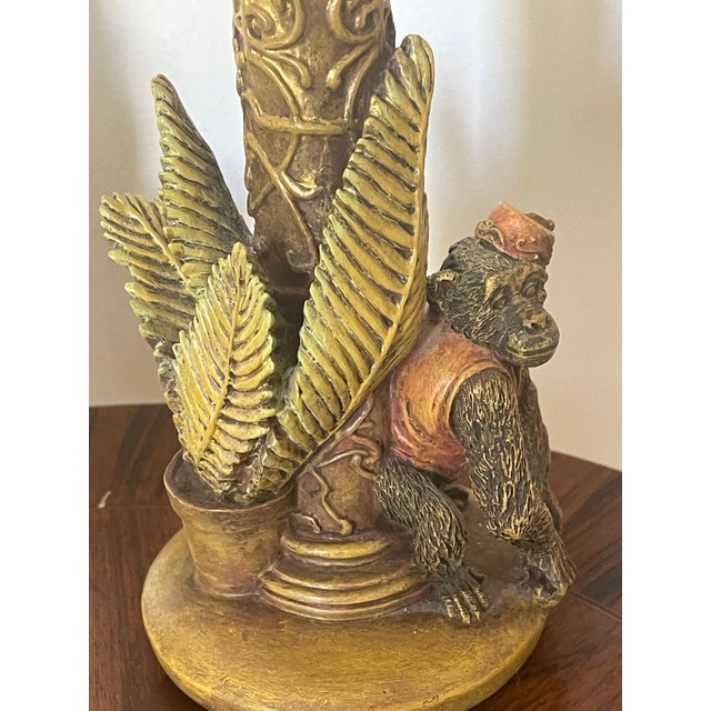 Vintage whimsical pair of safari themed candleholders with monkey figurines at base.
