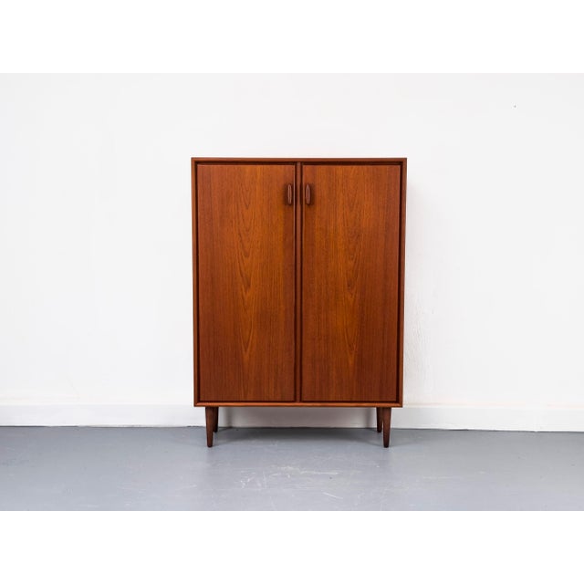 High-quality mid-century modern cabinet by RT Möbel from the 1960s. Made of reddish-brown teak with a simple,...