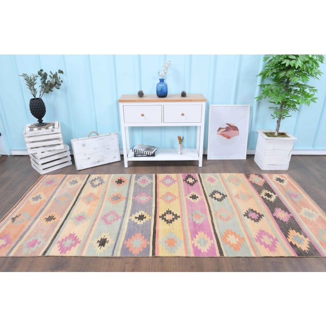 Vintage Turkish Hand-Knotted vintage rug is a semi-Vintage kilim runner rug.'70s Eastern region of Turkey's unique rug is...