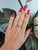 A 1.02-carat padparadscha sapphire glows in a warm blend of pink and orange at the centre of this solid 14K yellow gold...