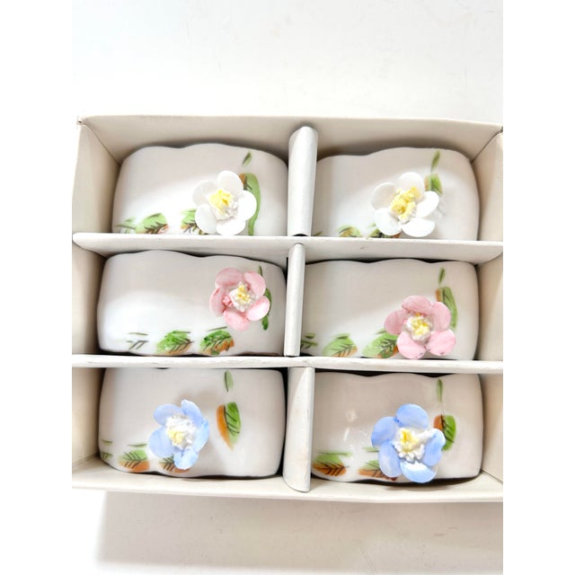 Charming Shafford China vintage porcelain napkin rings featuring hand-painted floral motifs and sculptural applied...