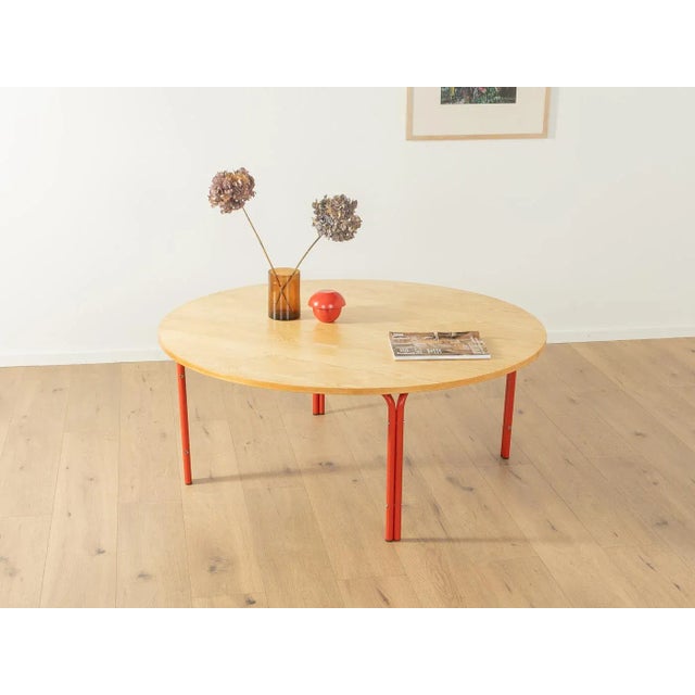 Minimalist coffee table from the 1980s. High-quality frame made of red painted tubular steel with a table top in ash...
