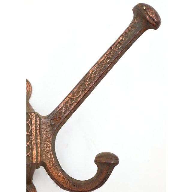 Vintage chain link design wall hook made of cast iron with copper plating. The original mounting screws are not available....