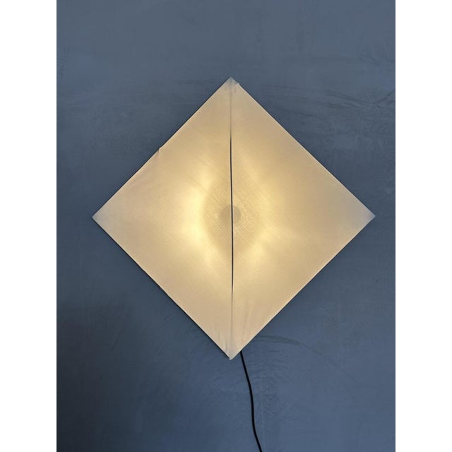 Wall lamp designed by Kazuhide Takahama for Sirrah, under art direction by dino Gavina inspired by the cuts of Lucio...