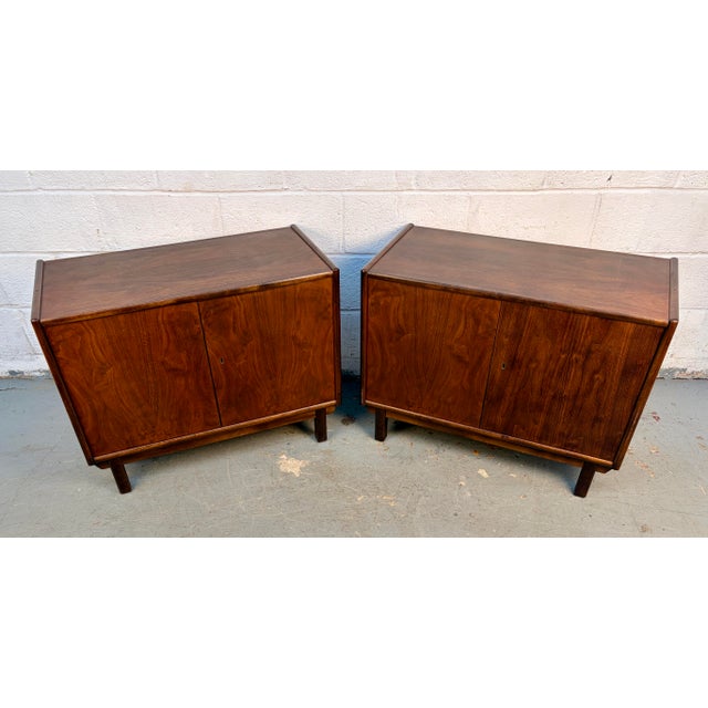 A beautiful pair of mid-century modern locking cabinets crafted from richly grained walnut. Each piece features clean...