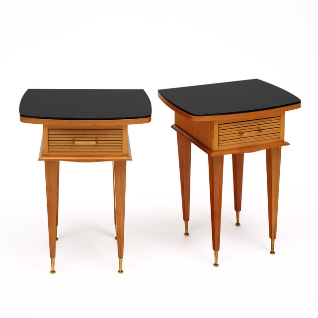 Side tables from France in the period mid-century modern style. These tables are made of solid wood, primarily cherry....