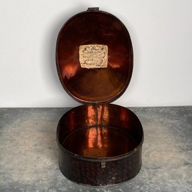 A 19th Century English painted tole hat box.