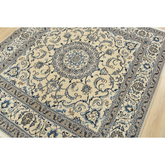 An authentic vintage traditional Nain rug hand-knotted with fine wool and natural dyes. This oriental rug features a...