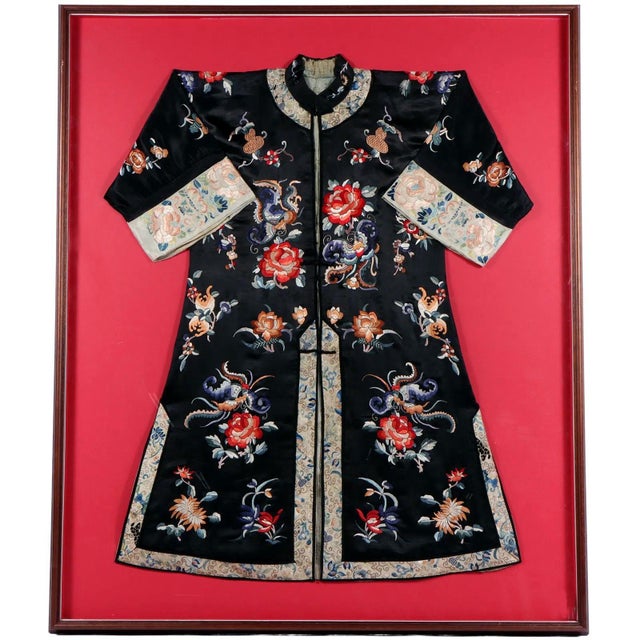 A woman's coat made of black stain silk with wide sleeves from China late Qing Dynasty (late 19th to early 20th century),...