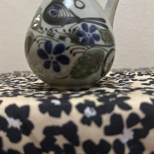 Add a touch of rustic charm and cultural artistry to your space with this beautiful Mexican pottery bud vase. Featuring a...