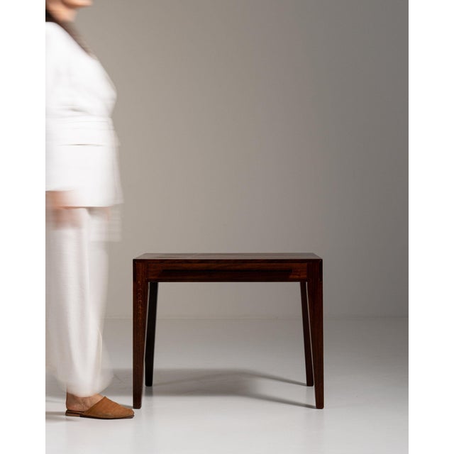 Walnut side table in Rich Walnut Brown. The rich walnut brown surface highlights clean tapered legs, simple rectangular...