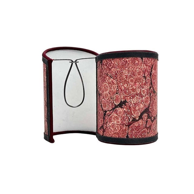 Marble paper narrow half shades in red trimmed with two colors of grosgrain. Measuring 5" x 3" x 2" deep , sold in pairs....