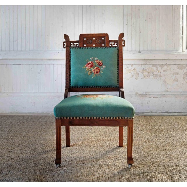 Antique Aesthetic Movement chair with needlepoint upholstered seat and backrest and hand carved detail. Front legs have...